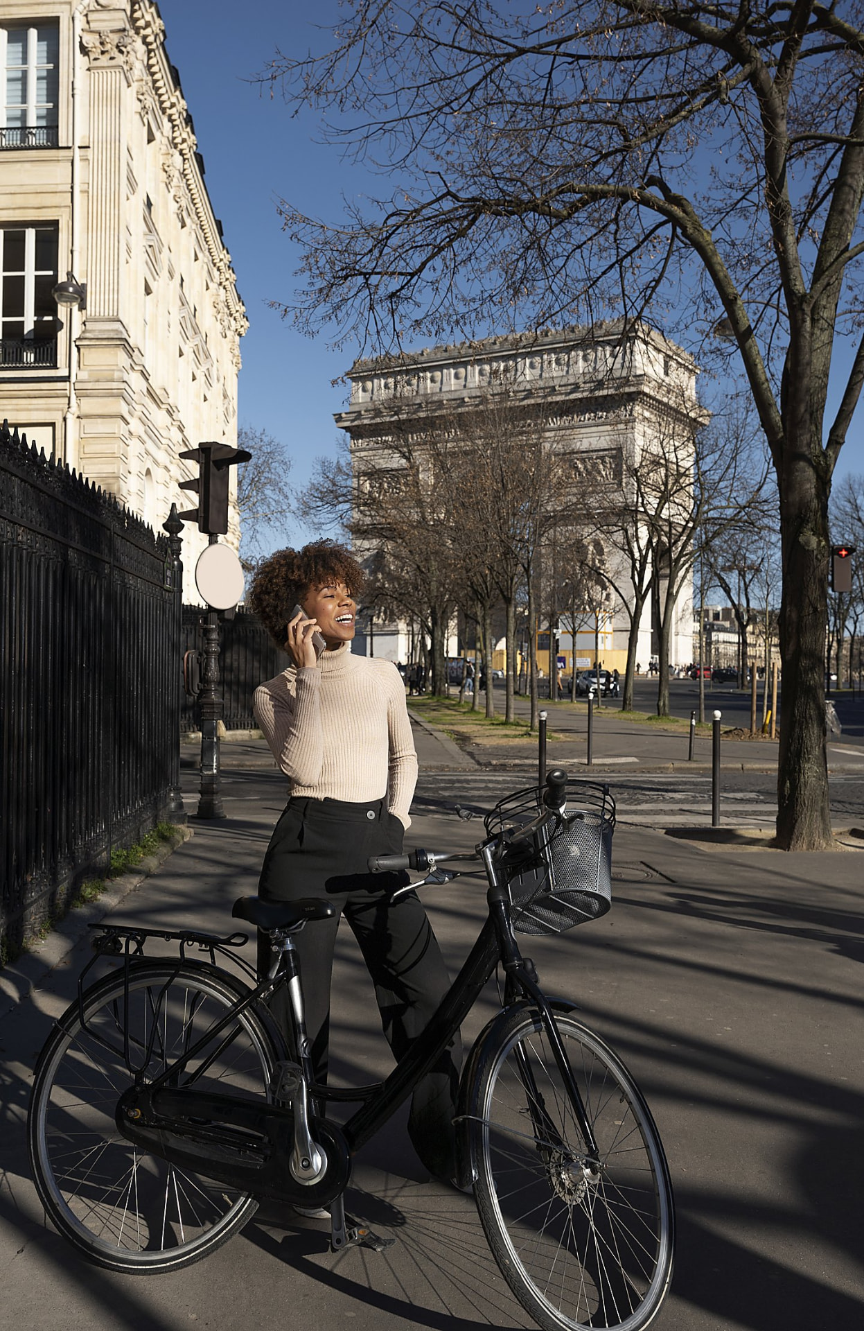 Woman on the phone with her bike in the city
